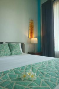 吉利特拉旺安兰布兰别墅 的一间卧室,床上放着鲜花
