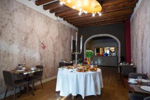 威尼斯Riva del Vin BOUTIQUE HOTEL的用餐室配有餐桌和食物