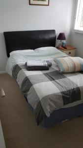 彼索普斯托福Fully Equipped Modern 3 bedroom House的卧室内的一张带两个枕头的床