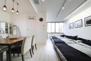 滨松Culinary Bed&Art 401的一间带长床和桌子的用餐室