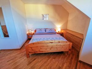 布莱德高山湖泊公寓的一间卧室配有木床和2个床头柜