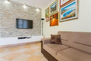珀德垂那Apartment Montegraso的带沙发和石墙的客厅