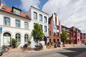 胡苏姆Nordsee-Hotel Hinrichsen的街道上拥有建筑和自行车的城市街道