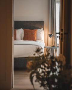 Lonmore哈姆斯克酒店的一间卧室配有带橙色和白色枕头的床