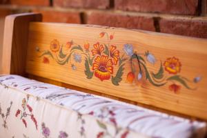 Rosochaty RógSiedlisko Wigry的木头床头板,上面有花卉图案