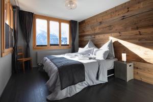 哈斯利伯格Alp n' rose的一间卧室设有一张带木墙的大床