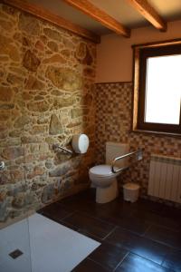 VillastoseO Cabanel Albergue-Bar的一间带卫生间和石墙的浴室
