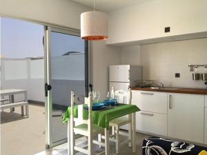 查德尔帕罗奥Sunny Studio Lanzarote的厨房配有绿色的桌椅