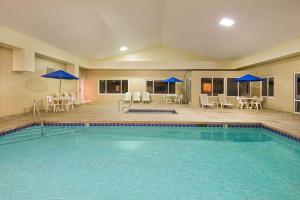 费利蒙弗里蒙特戴斯酒店的一个带蓝伞和桌椅的游泳池