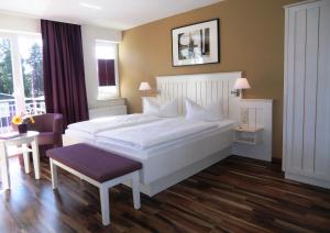 塞巴特阿尔贝克德利亚维尔旅馆的卧室配有一张白色的大床和一张桌子