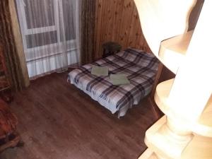 科索夫Hotel Dudarik的木制客房内的一间卧室,配有一张床