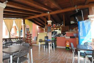 拉蒂纳普力马维拉别墅公寓的一间带桌椅的餐厅和一间酒吧