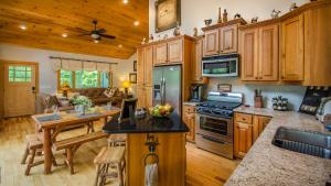 富兰克林Red Cedar Cabin的一间带木制橱柜和桌子的厨房以及一间用餐室