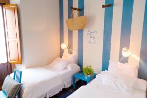 阿兰约兹埃尔科赫隆酒店的一间设有两张床和蓝白条纹的房间