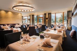 奥伯斯特多夫优雅酒店的餐厅设有白色的桌椅和窗户。