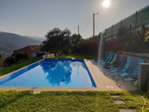 拜昂Casas do Casinhoto - Casa Vista Aregos的一个带椅子的游泳池,位于墙上