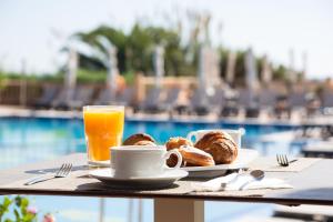 米乔尔海滩艾斯皮2旅馆的一张桌子,上面放着一盘糕点和一杯橙汁