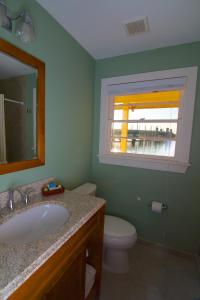 圣奥古斯丁Edgewater Inn - St. Augustine的一间带水槽和卫生间的浴室以及窗户。