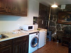 雷森迪Casa do Lagar的厨房配有洗衣机和微波炉。