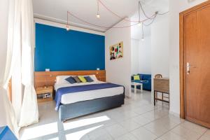维泰博维泰博酒店的一间卧室设有一张床和蓝色的墙壁