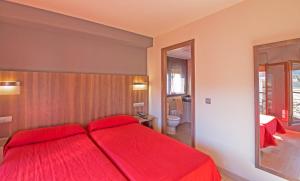 塞奥-德乌赫尔大道酒店的一间卧室配有红色的床和红色毯子