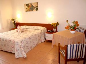 塔皮安诺Albergo Elvira的酒店客房设有一张床和一张桌子