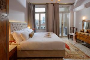 雅典Athenian Vintage Apartments的卧室设有一张白色大床和一扇窗户。