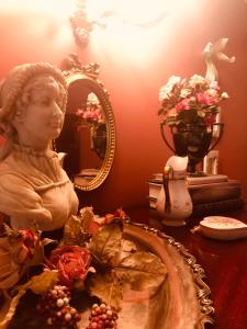 Princess AnnePrincess Anne Book Lovers Inn的一张桌子,上面有一身穿插在胸罩上的雕像和镜子