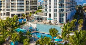 迈阿密海滩阳光岛艾美海滩度假村 的享有棕榈树和建筑度假村泳池的空中景致