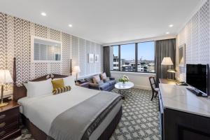 布里斯班View Brisbane的酒店客房设有一张大床和一台电视。