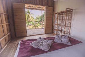 高龙撒冷岛Bonsai的窗户和床罩的房间里一张床位