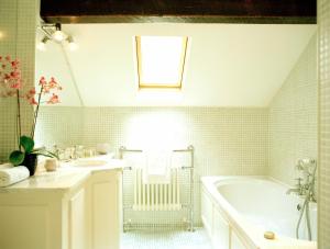 阿瑟斯敦邓布鲁蒂田园酒店的白色的浴室设有浴缸和水槽。