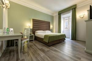 罗马BB Hotels Smarthotel Bailey's的一间卧室配有一张床、一张桌子和一张书桌