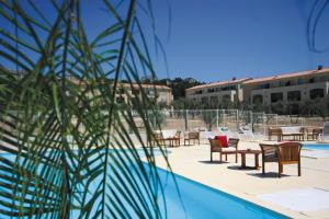 帕拉杜朵麦恩博日科拉格朗日度假公寓式酒店的享有带桌椅的游泳池的景致。