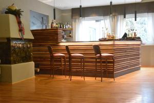 博萨迪法萨大白塔家庭酒店的吧台前有四把凳子的酒吧