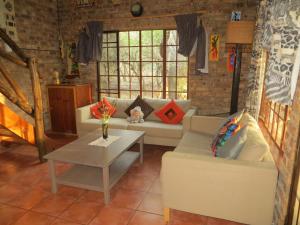 玛洛斯帕克Kruger Safari Animal Encounter的客厅配有沙发和桌子