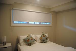布里斯班Victoria 53的卧室配有白色的床和窗户