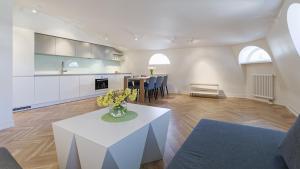 塔林Great apartament in a heart of Tallinn的一间带白色桌子的客厅和一间厨房