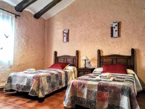 塞利亚Casa rural Las Masadas的一间卧室,配有两张床