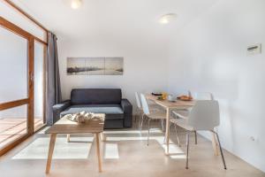 坎布里尔斯Agaró Cambrils Apartments的客厅配有沙发和桌子