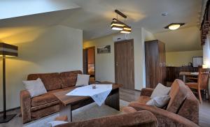 赖曼瑙-兹德鲁伊苏珊娜Spa旅馆的客厅配有沙发和桌子