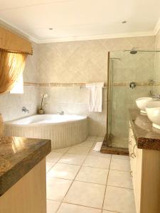 察嫩拉巴露恩旅馆的带浴缸、水槽和淋浴的浴室