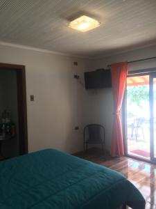 帕拉尔Quinta el Rosal的一间卧室设有一张床和一个滑动玻璃门