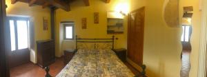 San Demetrio neʼ VestiniIL MIGNOLO DI SAN GIOVANNI的卧室配有一张床铺,位于一个黄色墙壁的房间