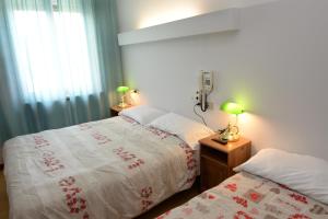 瓦拉泽潘塔贝拉酒店的一间卧室设有两张靠窗的床。