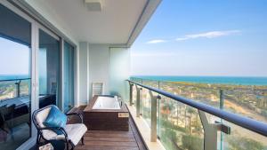 三亚三亚海棠湾尼尔亚特海景度假公寓<亚特兰蒂斯度假区店>的设有一个配有浴缸的海景阳台。