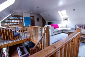 兰达西尔Ceridwen Holiday Home的一间带楼梯和沙发的客厅