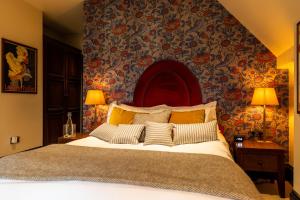 伦敦福克斯安可酒店的一间卧室配有一张带花卉壁纸的大床