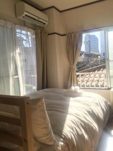 东京COCO Nakameguro301的一间卧室设有一张床和一个大窗户