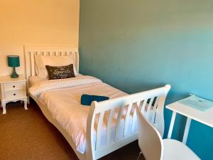 凯特林凯特林德班度假屋的卧室配有白色婴儿床和蓝色墙壁